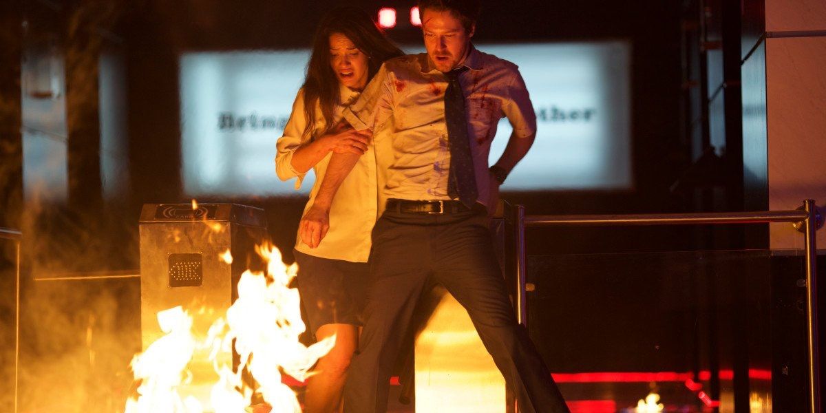 Adria Arjona avoiding fire in The Belko Experiment