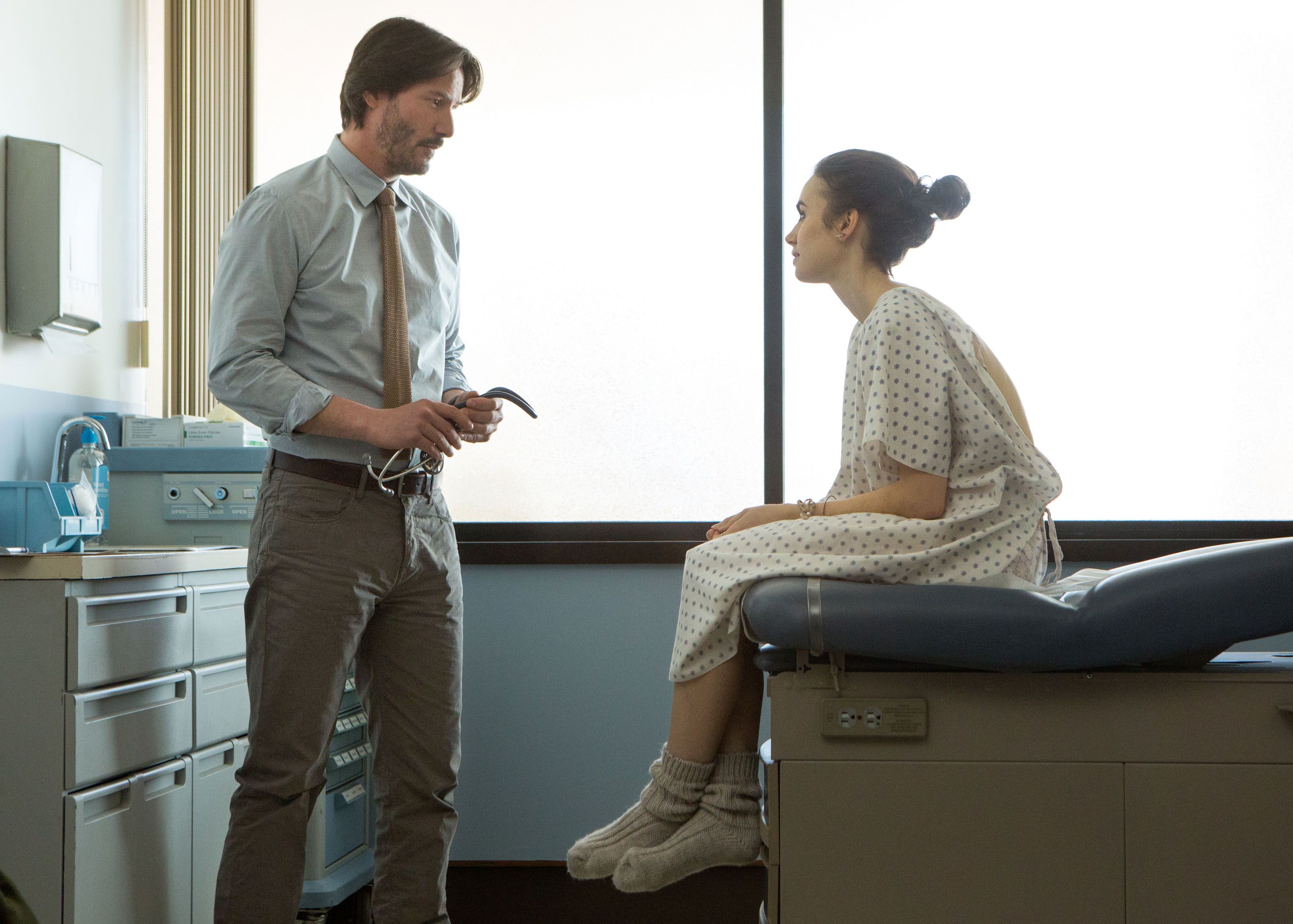 Lily Collins and Keanu Reeves in doctor's office in To the Bone