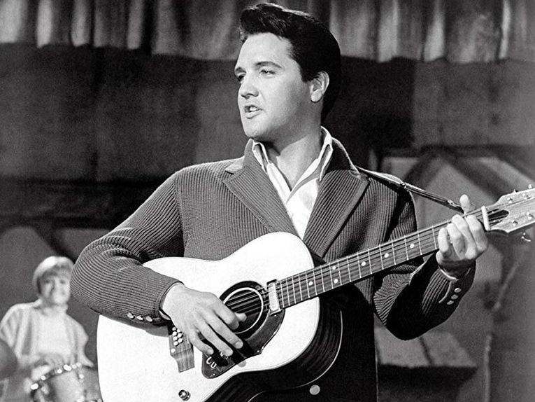 Elvis Presley singing on stage