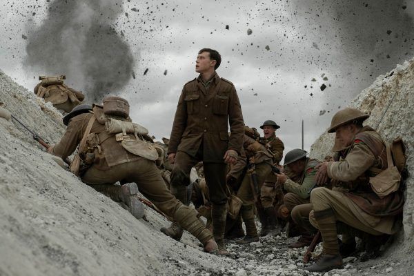 George Mackay as William Schofield with other soldiers in the trenches of '1917'
