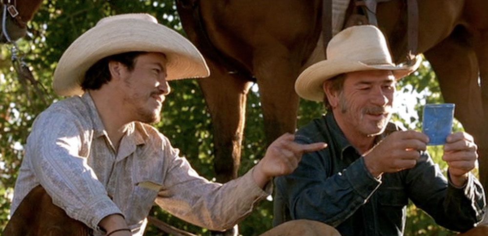 Julio Cedillo as Melquiades Estrada showing Tommy Lee Jones as Pete Perkins a picture of his family in 'The Three Burials of Melquiades Estrada'