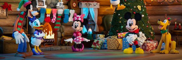 Mickey Mouse and friends gather in front of a Christmas tree.
