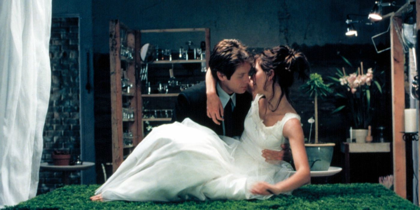 James Spader holding Maggie Gyllenhaal wearing a white dress in 'Secretary'.