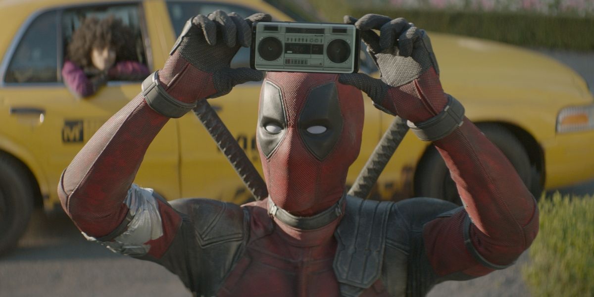 Ryan Reynolds as Deadpool holding up a boom box in Deadpool 2