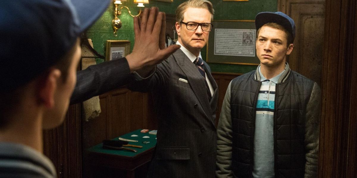 Colin Firth as Harry and Taron Egerton as Eggsy in front of a mirror in Kingsman: The Secret Service