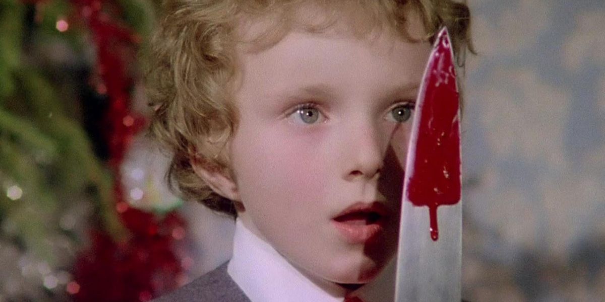 A child holding a bloody knife to their face in Deep Red