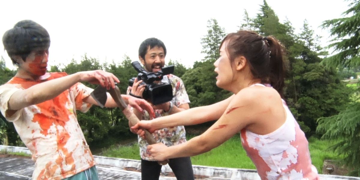 A director films an actress being attacked by a zombie