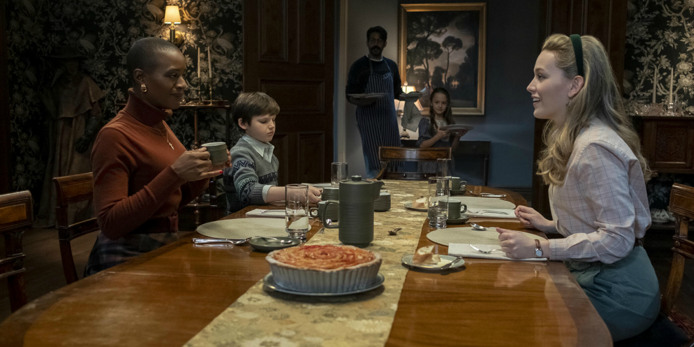 The residents of Bly Manor sit down to eat in The Haunting of Bly Manor.