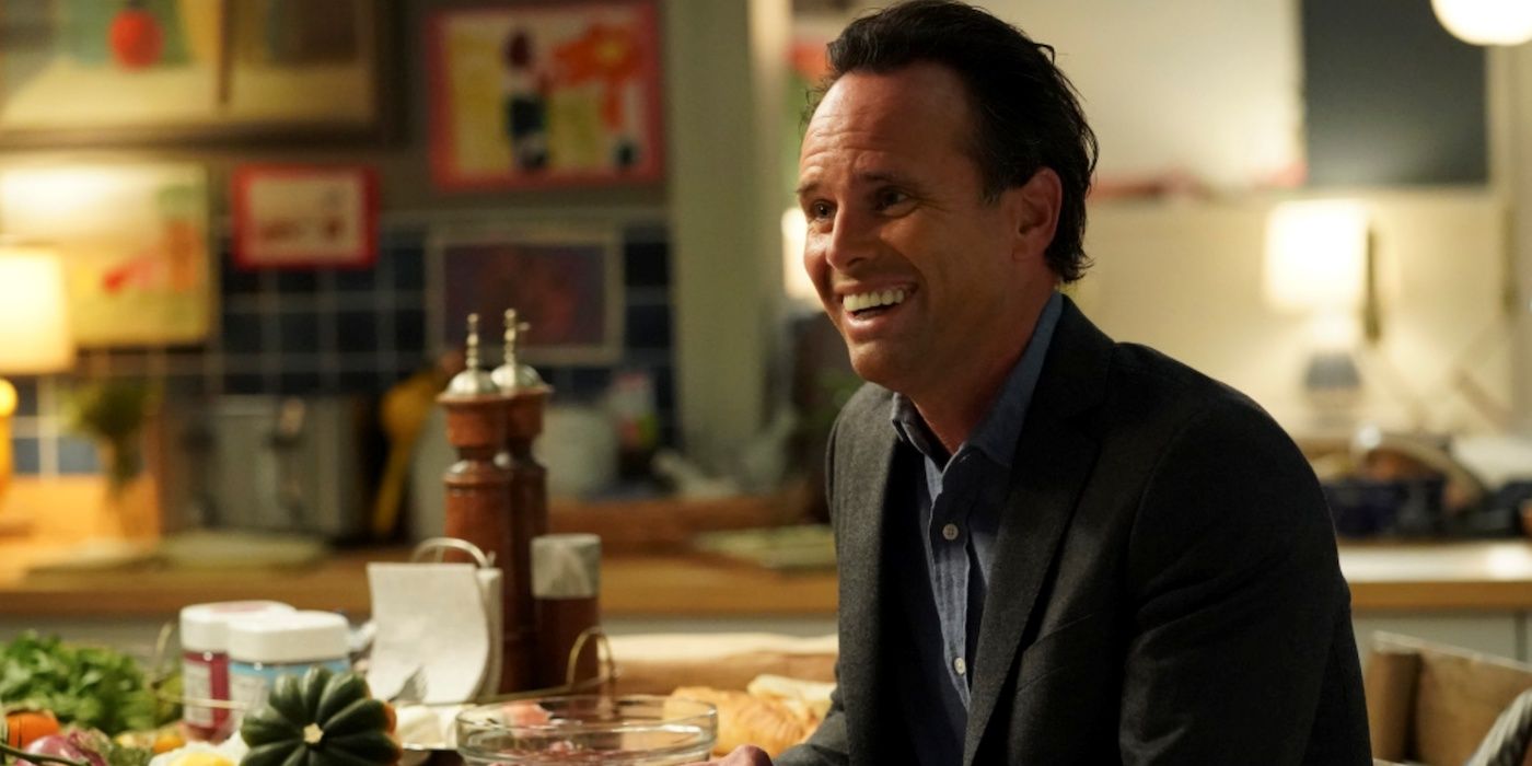 Walton Goggins as Wade Sitting in a kitchen and smiling widely in The Unicorn