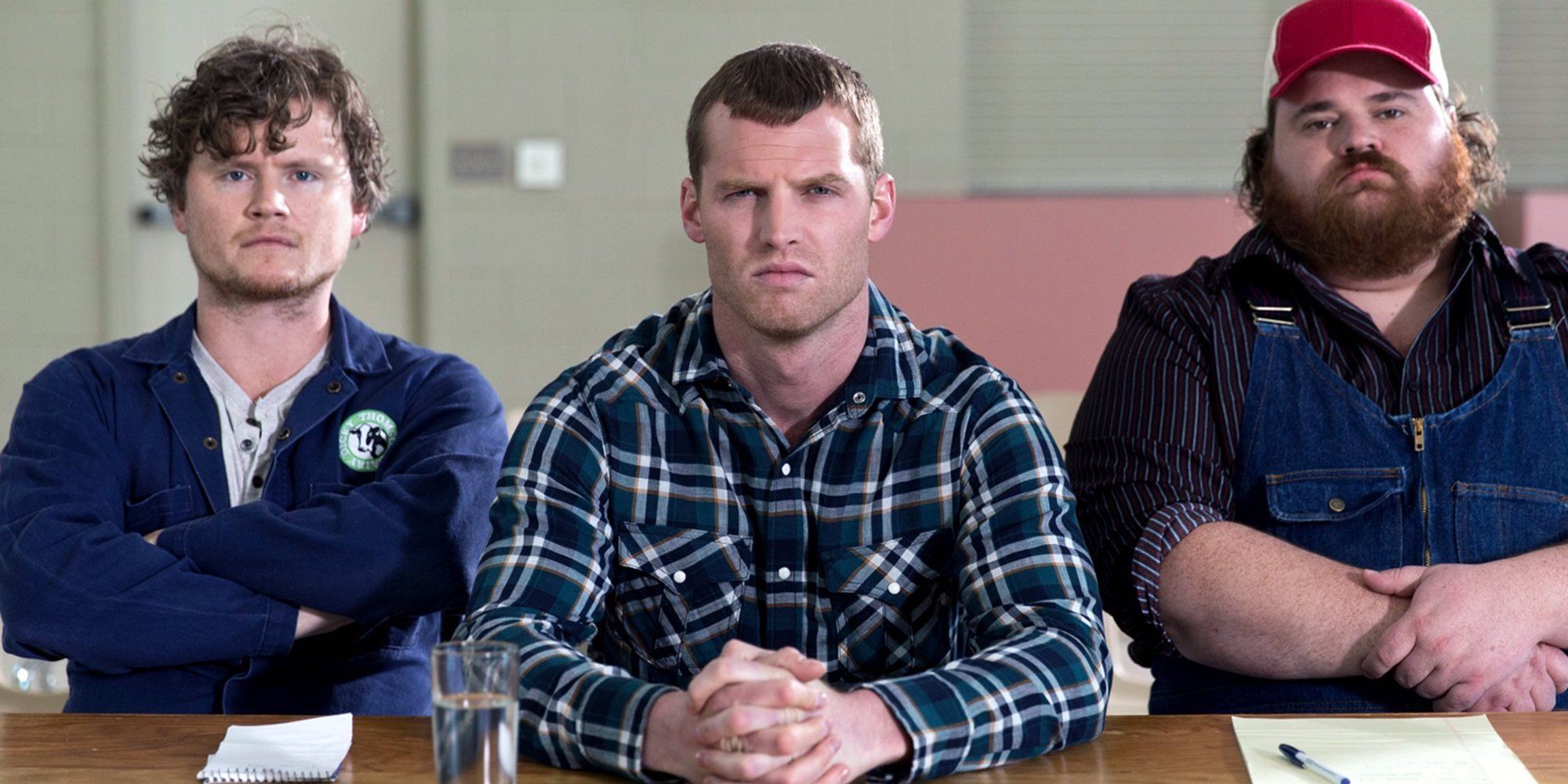 The cast of Letterkenny sitting in a table and looking straight to the camera.