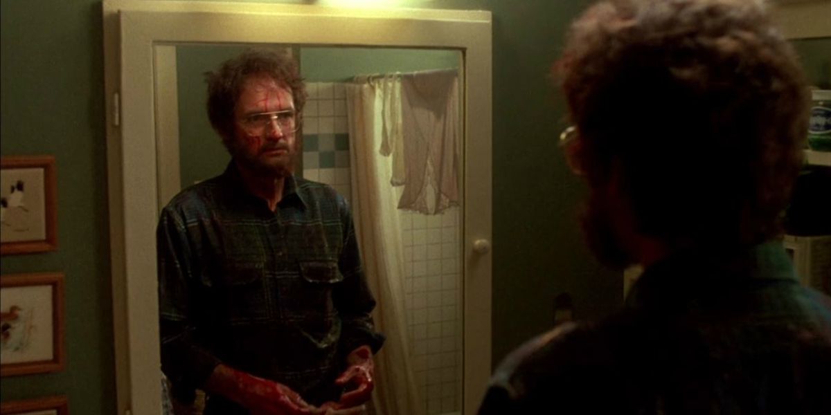 Terry O'Quinn as Jerry Blake looking in the mirror in The Stepfather.