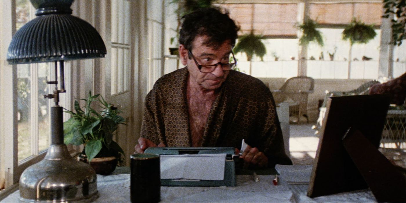 Walter Matthau sits at a typewriter wearing a robe and glasses in Hopscotch.