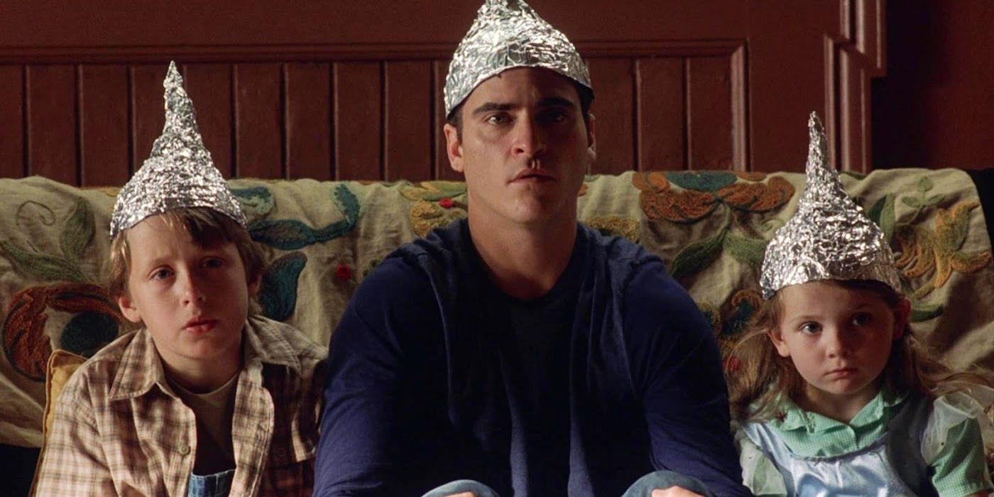 Rory Culkin, Joaquin Phoenix, and Abigail Breslin sport tinfoil hats in 'Signs'