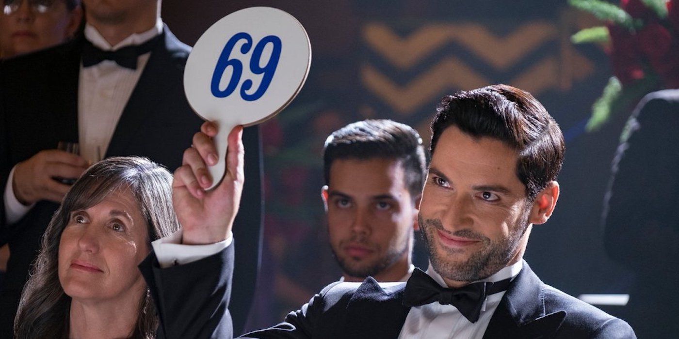 A man holding up a sign that says 69