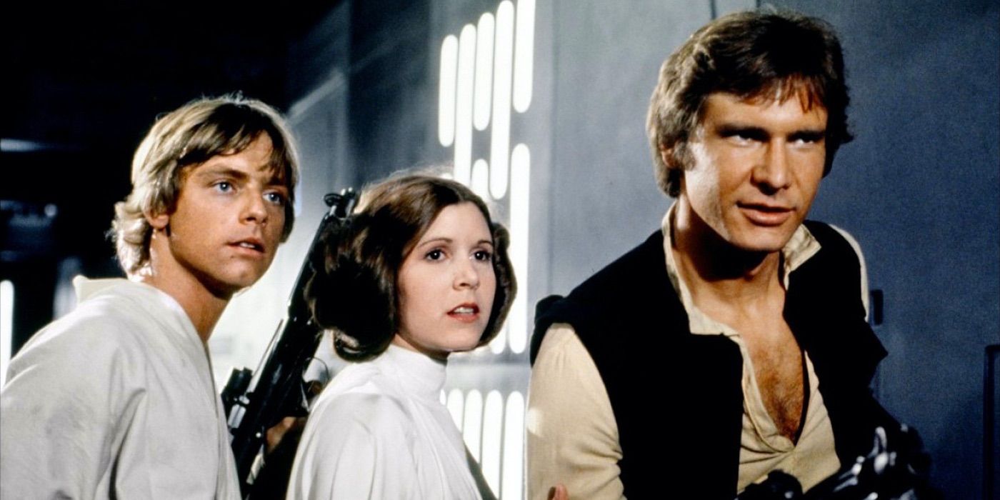 Mark Hamill, Carrie Fisher, and Harrison Ford as Luke, Leia, and Han looking in the same direction in Star Wars Episode IV A New Hope