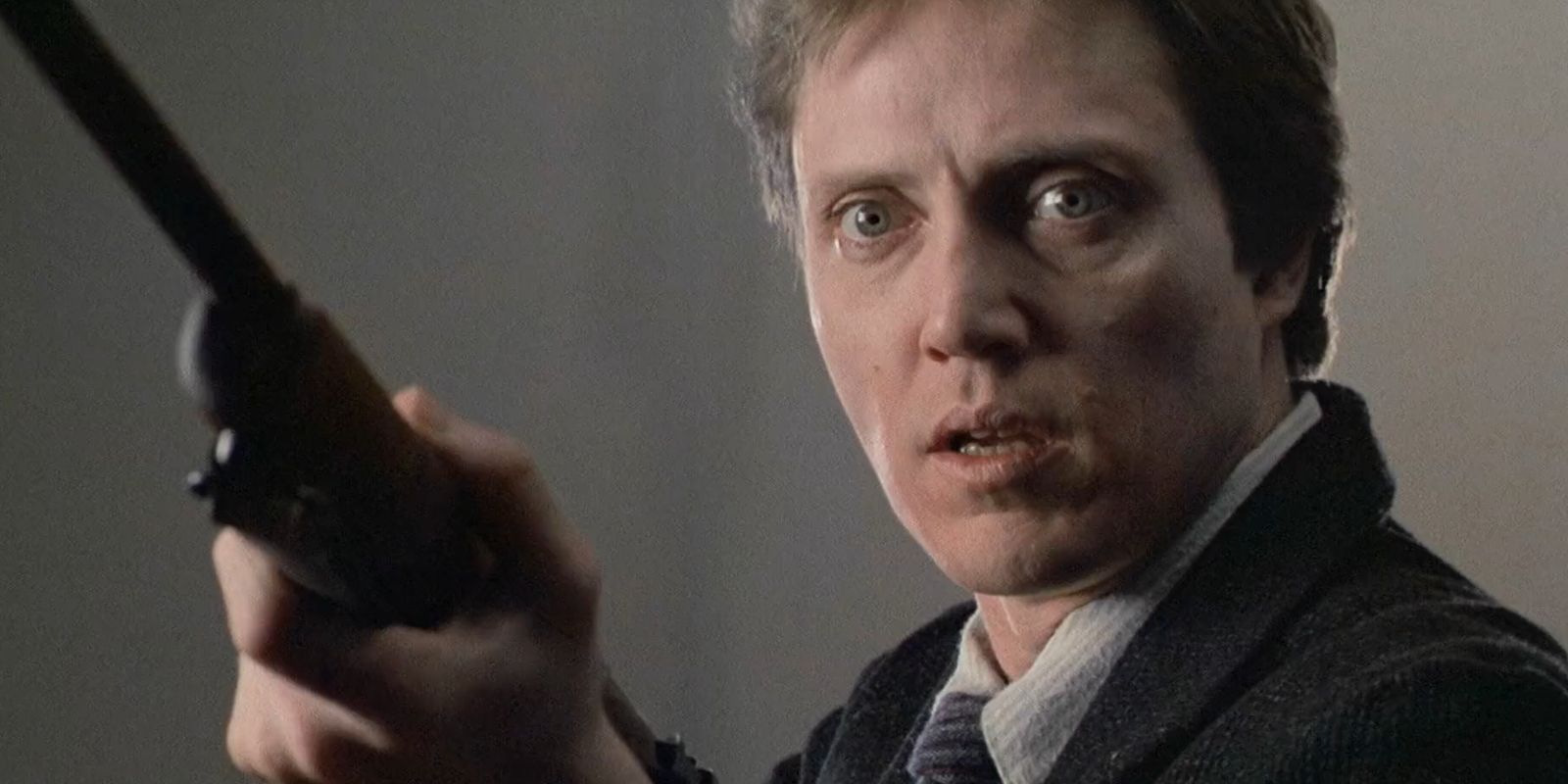 Christopher Walken holds a rifle in this still from The Dead Zone