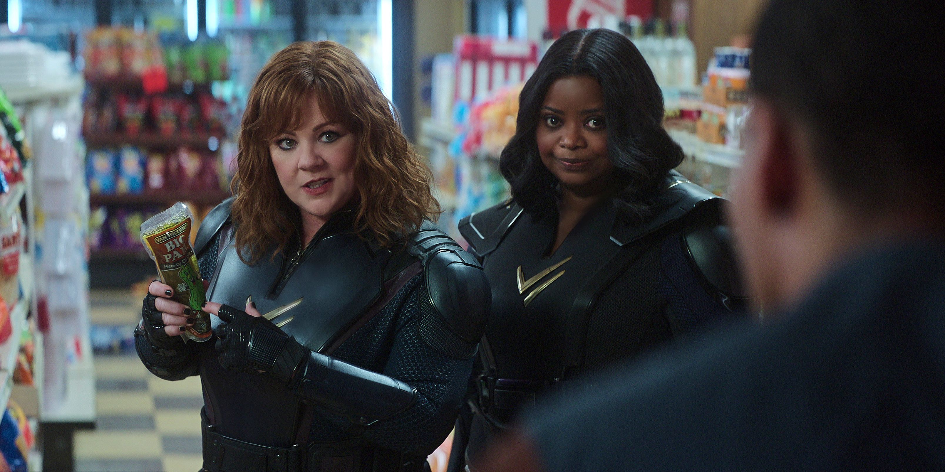 Melissa McCarthy and Octavia Spencer talkign to a man in Thunder Force