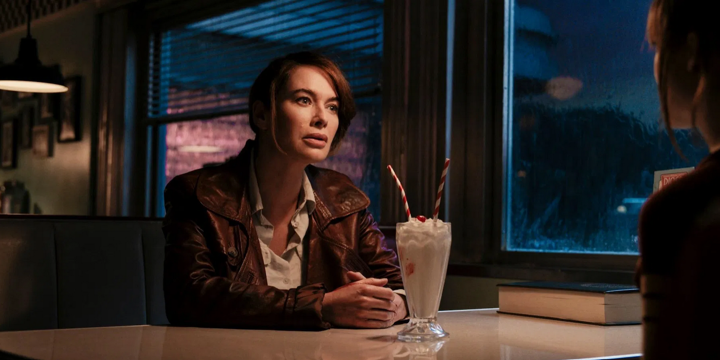 Lena Headey sitting with a milkshake in Gunpowder Milkshake
