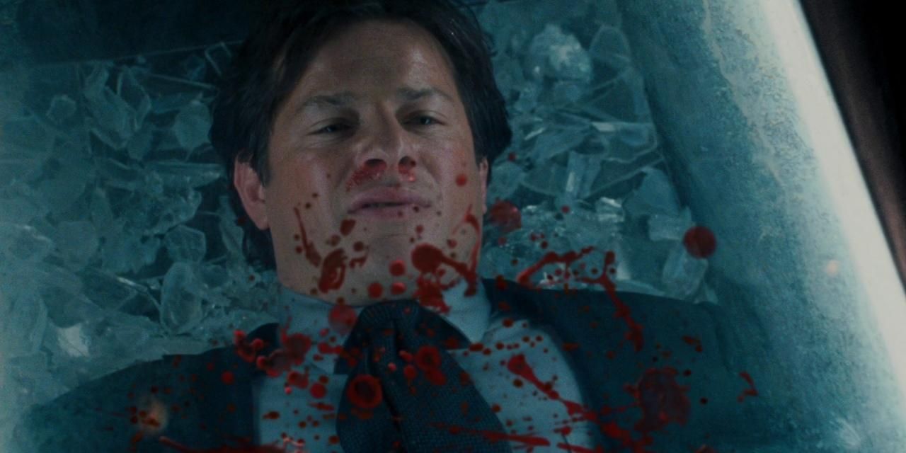 Costas Mandylor as Mark Hoggman in a glass box with blood splatter on it in Saw V.