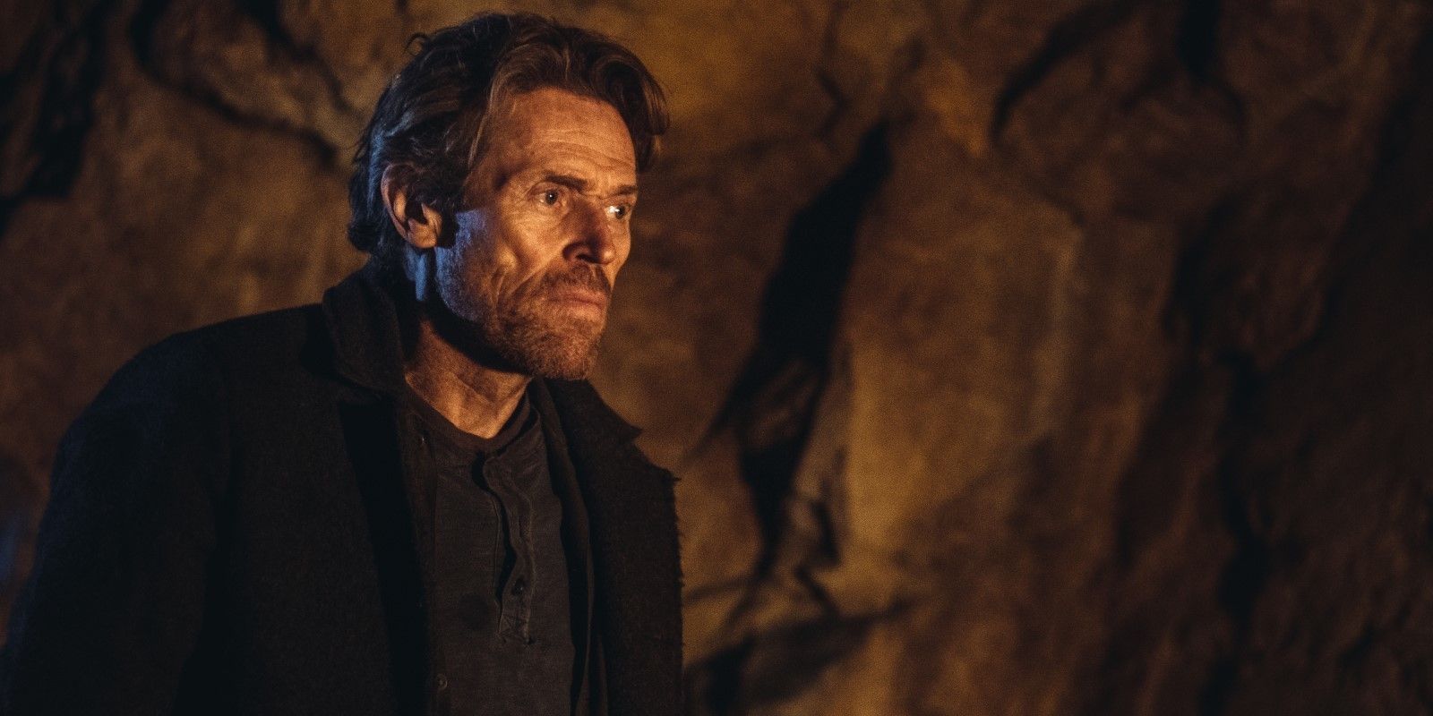 Clint in a cave looking intently in Siberia