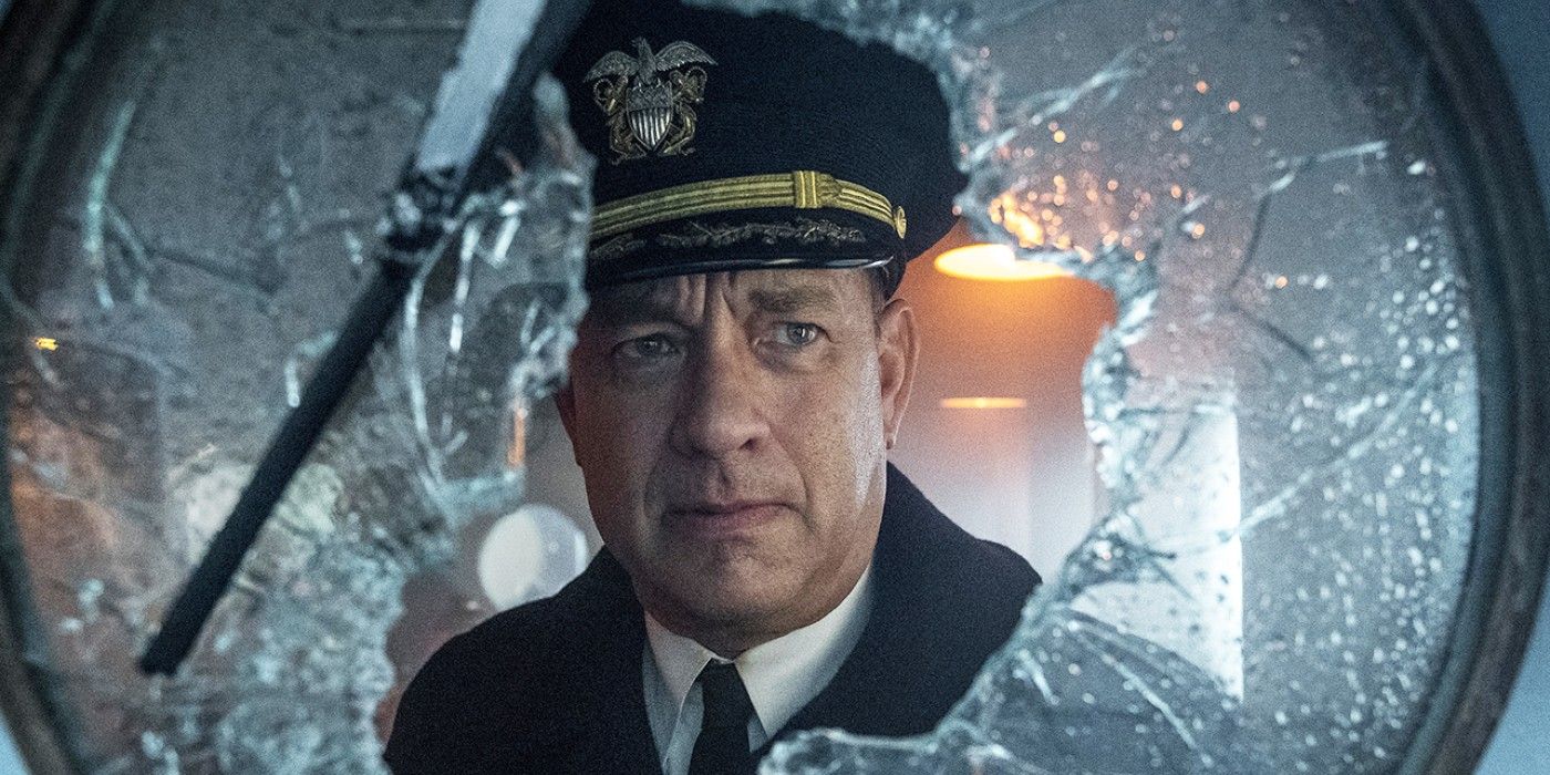 Tom Hanks as Commander Ernie Krause looking out a broken window in Greyhound.