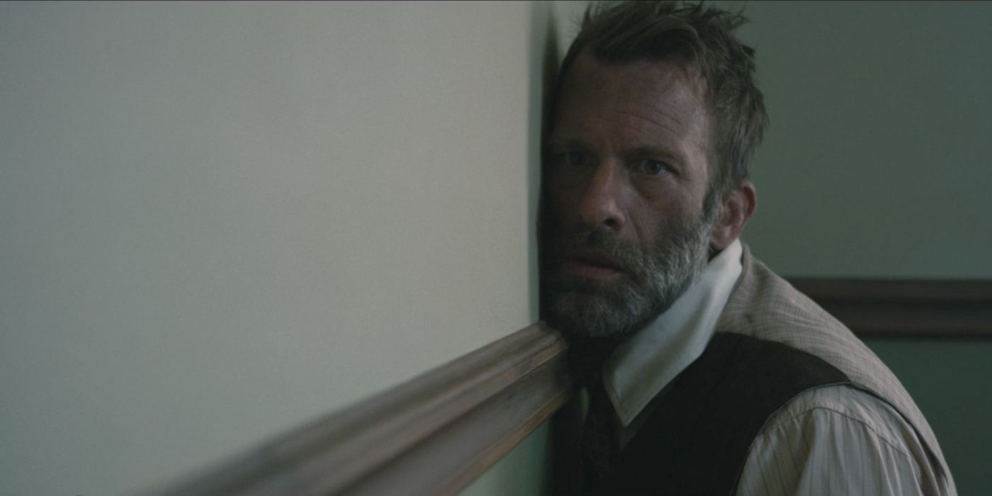 Thomas Jane leans against a wall while starring as Wilfred James in the film 1922, adapted from Stephen King's book