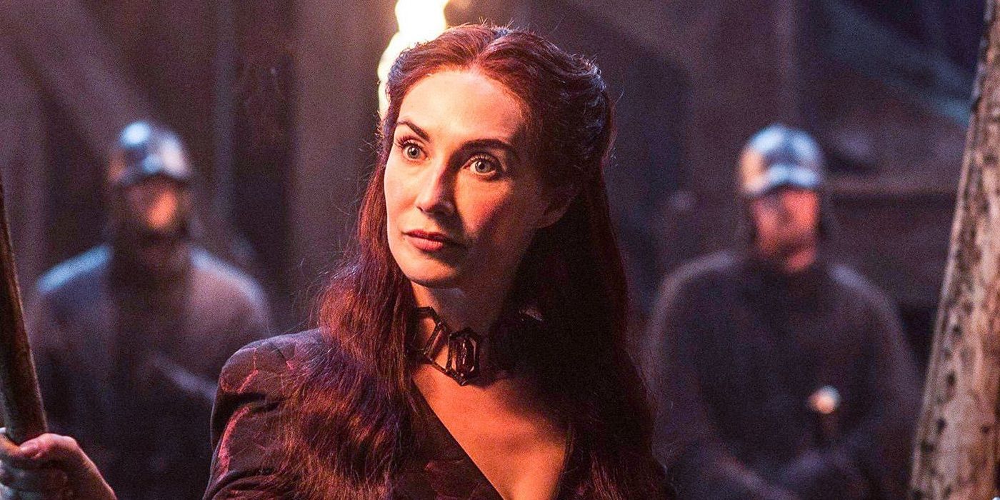 Carice van Houten holding a torch and looking curious in Game of Thrones.