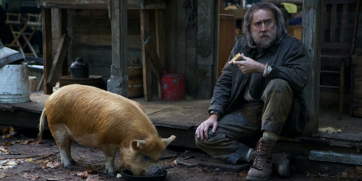 Un homme assis avec son cochon