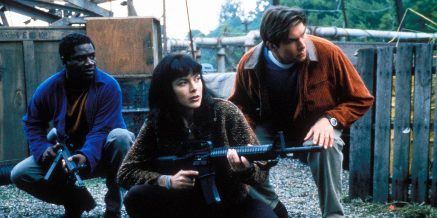 Three young people crouch down with guns in Sliders.