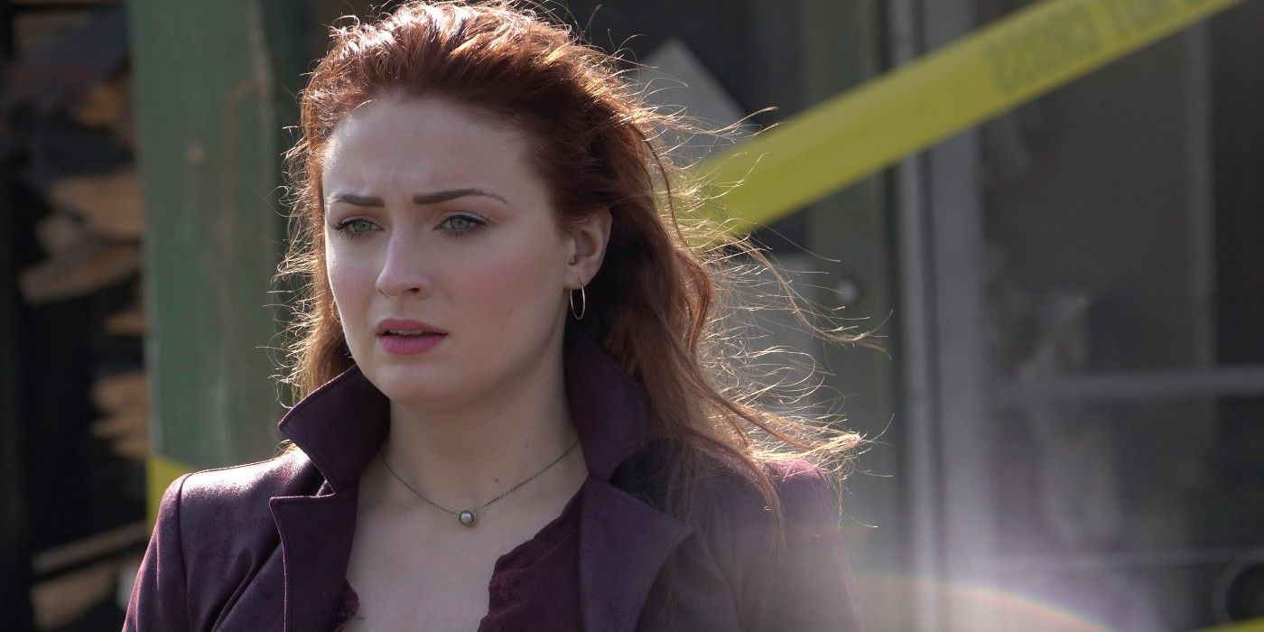 Sophie Turner as Jean Grey, wearing a burgundy jacket and looking sadly at something offscreen in Dark Phoenix