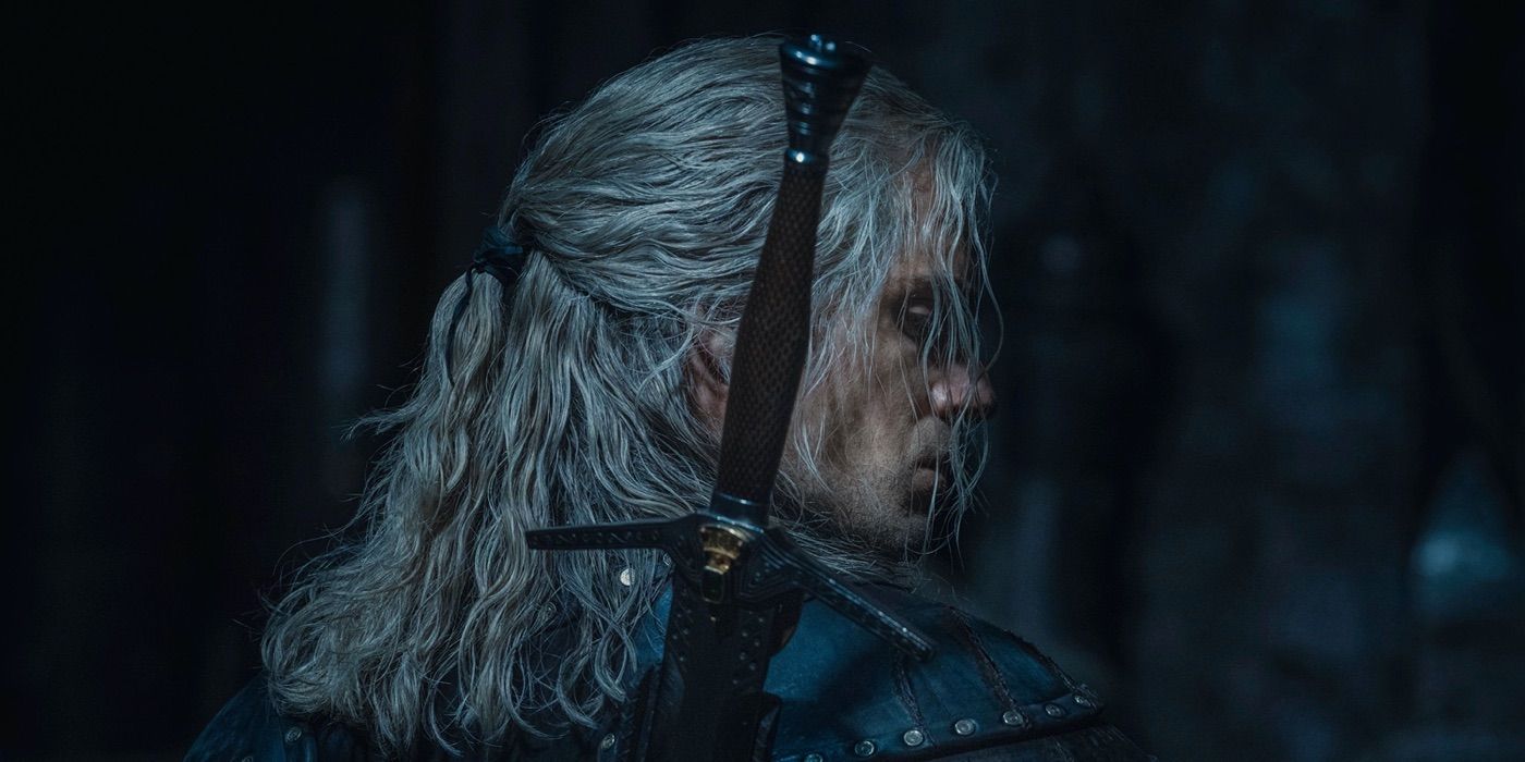 Henry Cavill as Geralt in The Witcher seen from the back with a sword on his back 