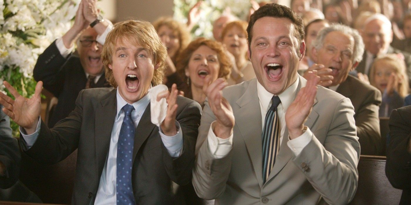 Owen Wilson and Vince Vaughn as John and Jeremy cheering while at a wedding in Wedding Crashers