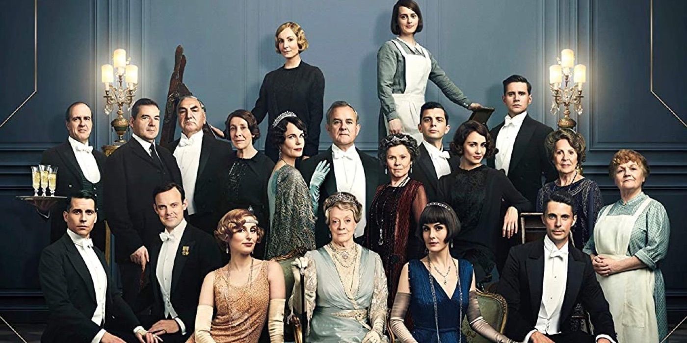 A poster from the downton abbey movie with the cast posed together inside the estate