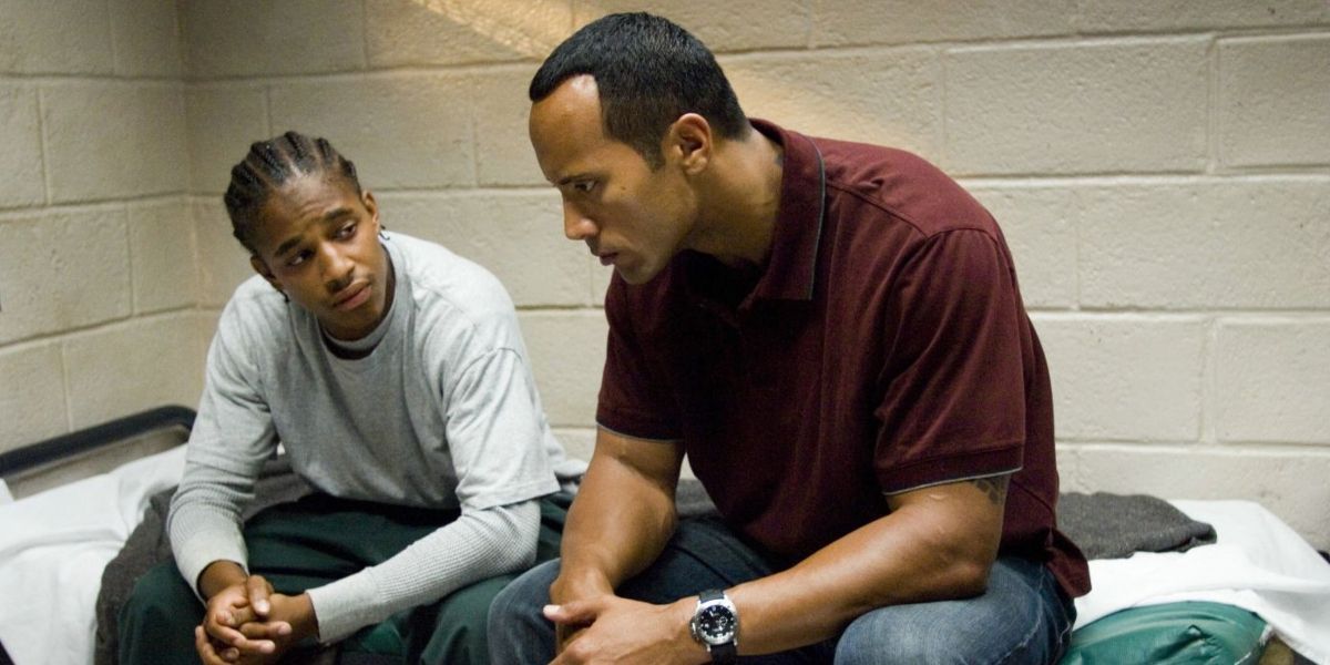 Dwayne Johnson talks to Jade Yorker, a student, in what looks like a jail cell