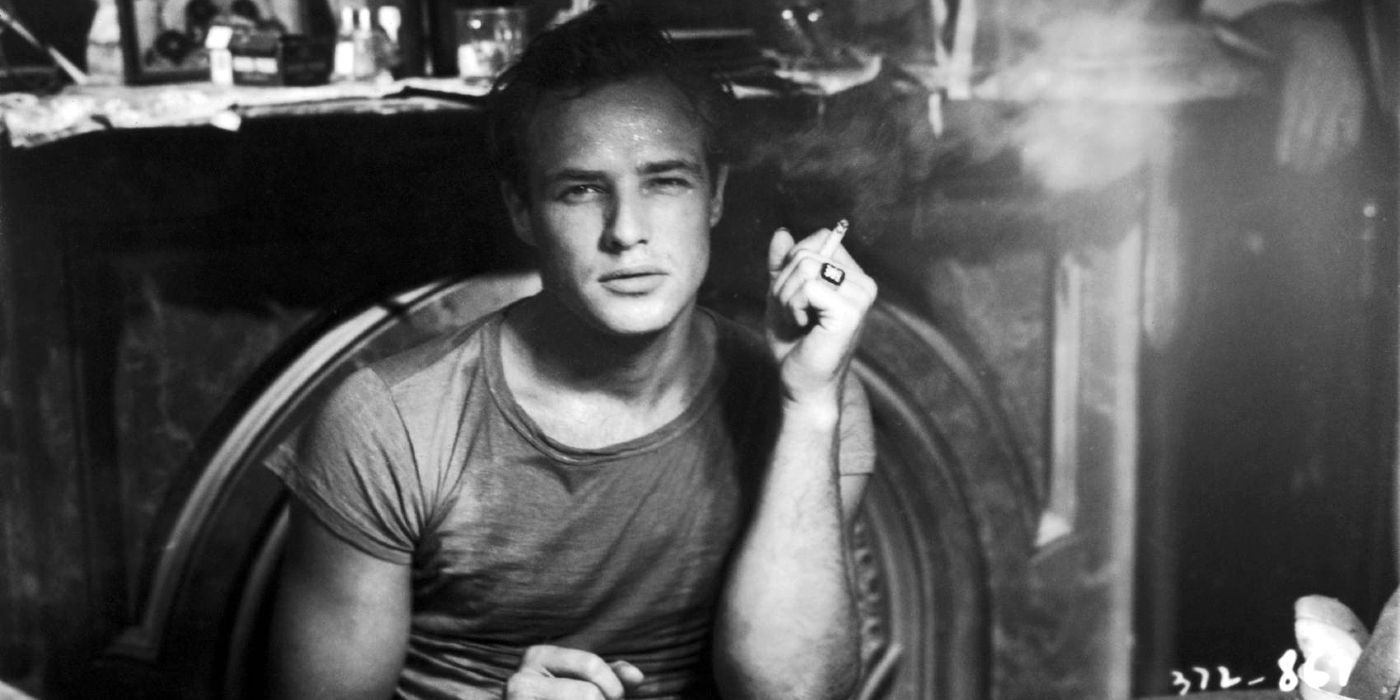Marlon Brando as Stanley Kowalski smoking and looking at the camera in A Streetcar Named Desire.