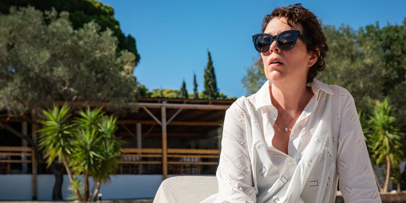 Olivia Colman sitting by a pool in The Lost Daughter.