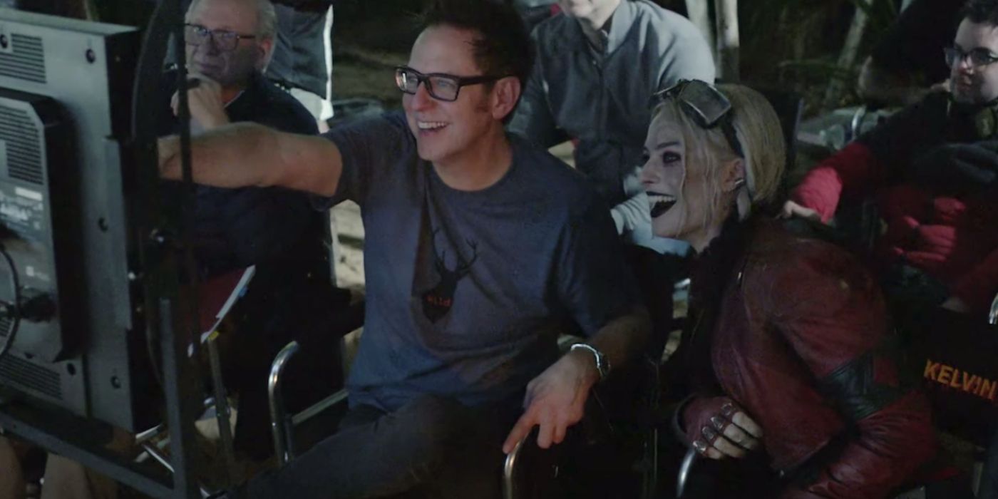 James Gunn and Margot Robbie looking at a camera on the set of The Suicide Squad