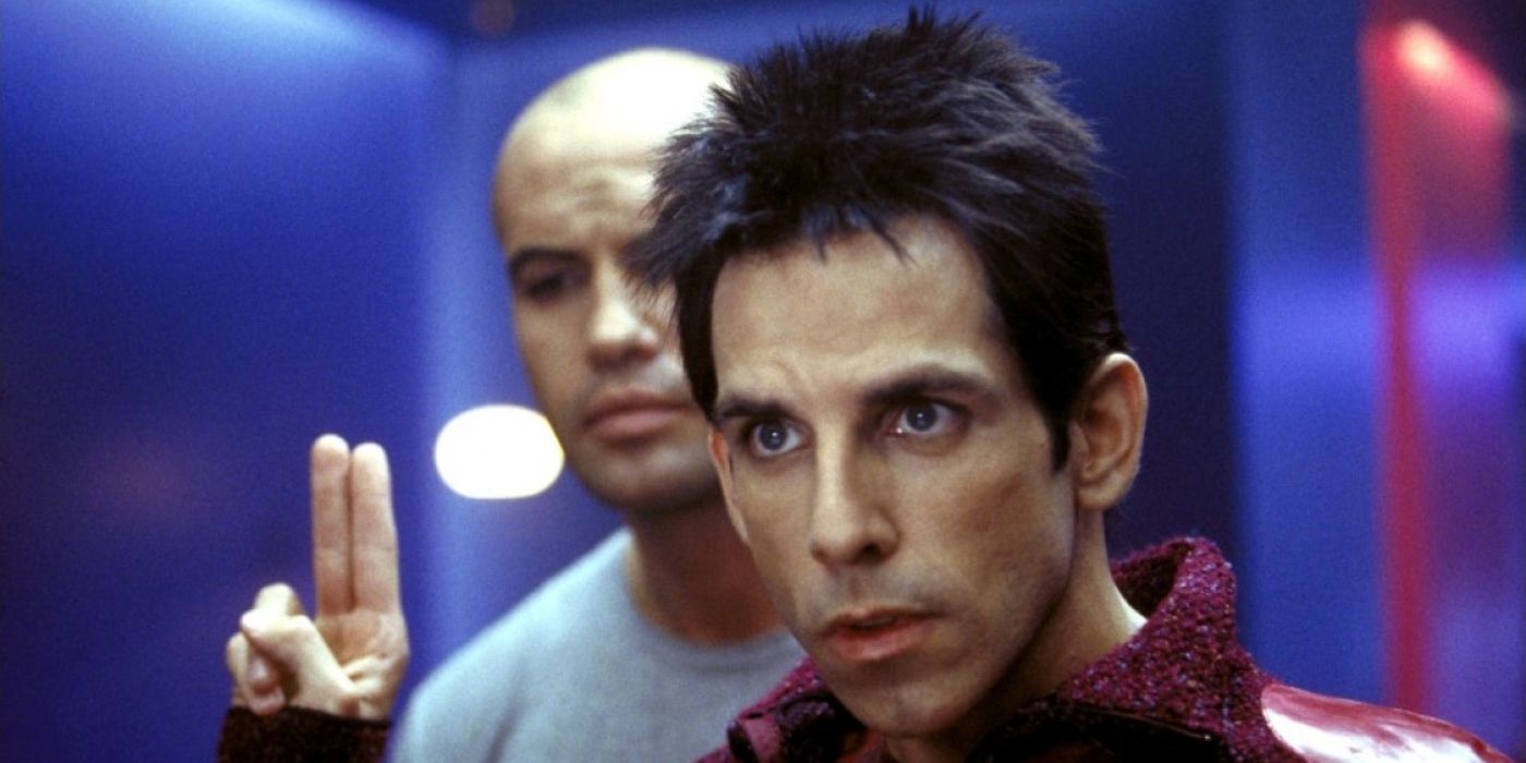 Ben Stiller as Zoolander, holding up two fingers, a man in the background.