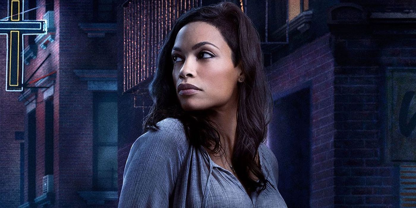 Rosario Dawson poses in front of a city backdrop in a poster for Daredevil.