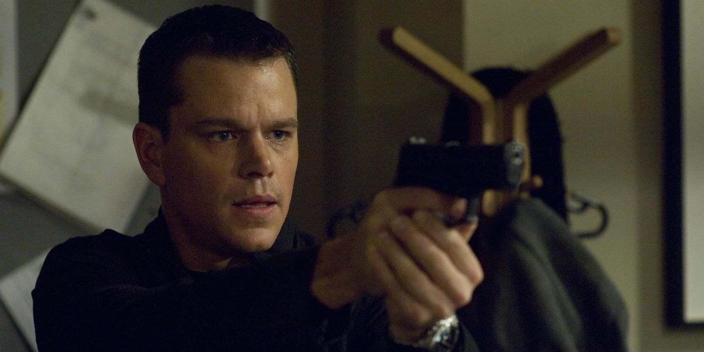 Matt Damon as Jason Bourne pointing a gun at someone in the film The Bourne Ultimatum