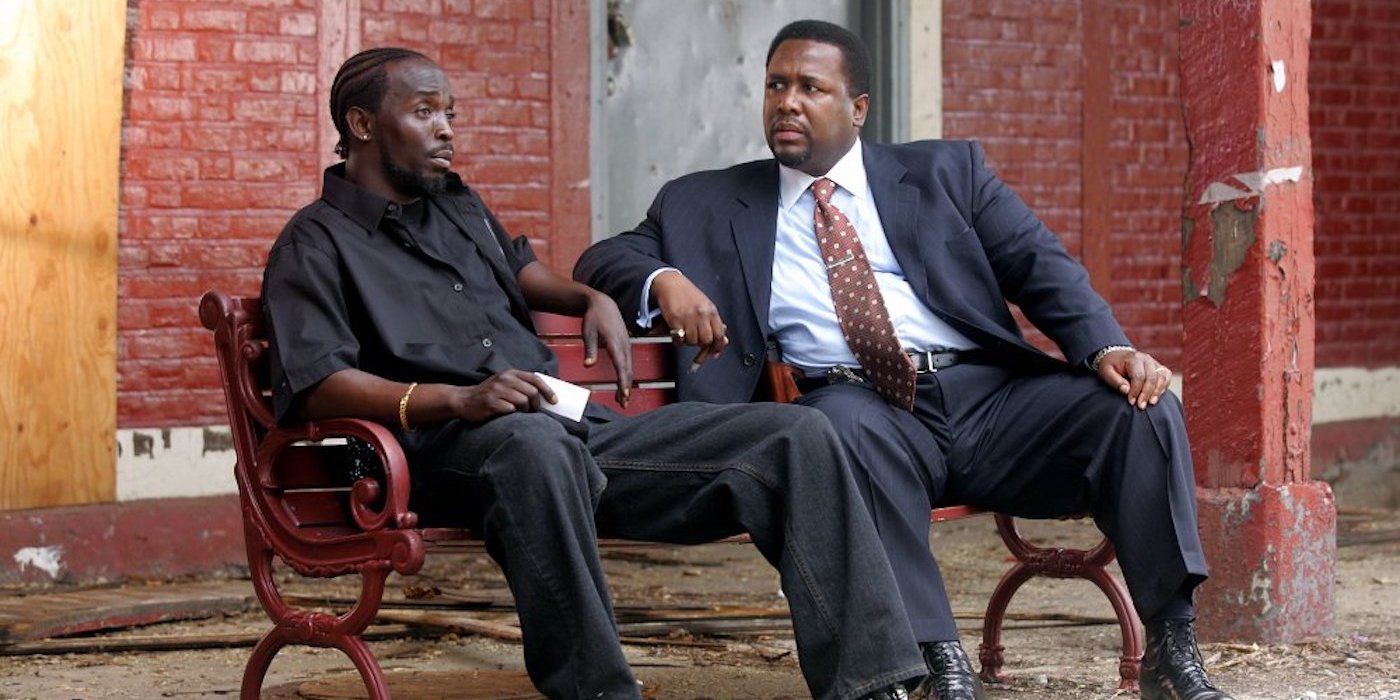 Michael K. Williams as Omar Little and Wendell Pierce as Bunk sitting on a bench on The Wire