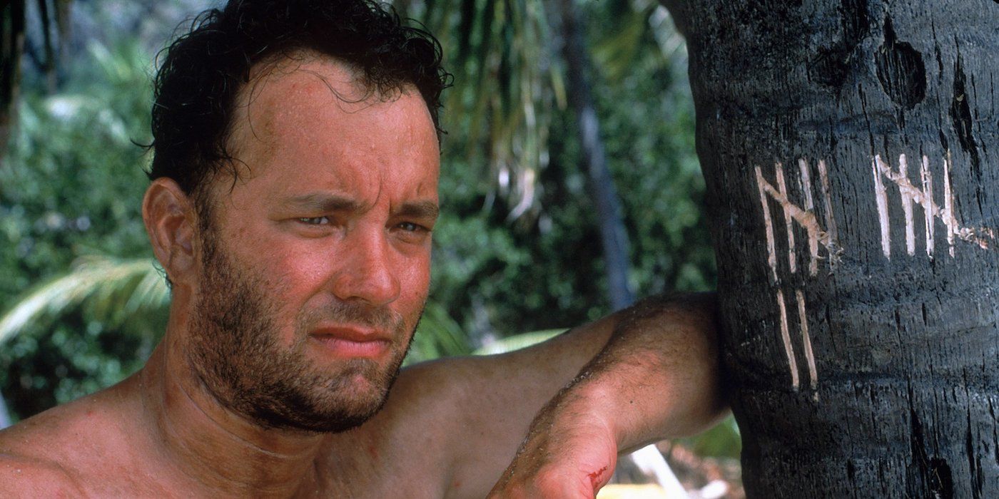 Tom Hanks leaning against a tree in 'Cast Away'