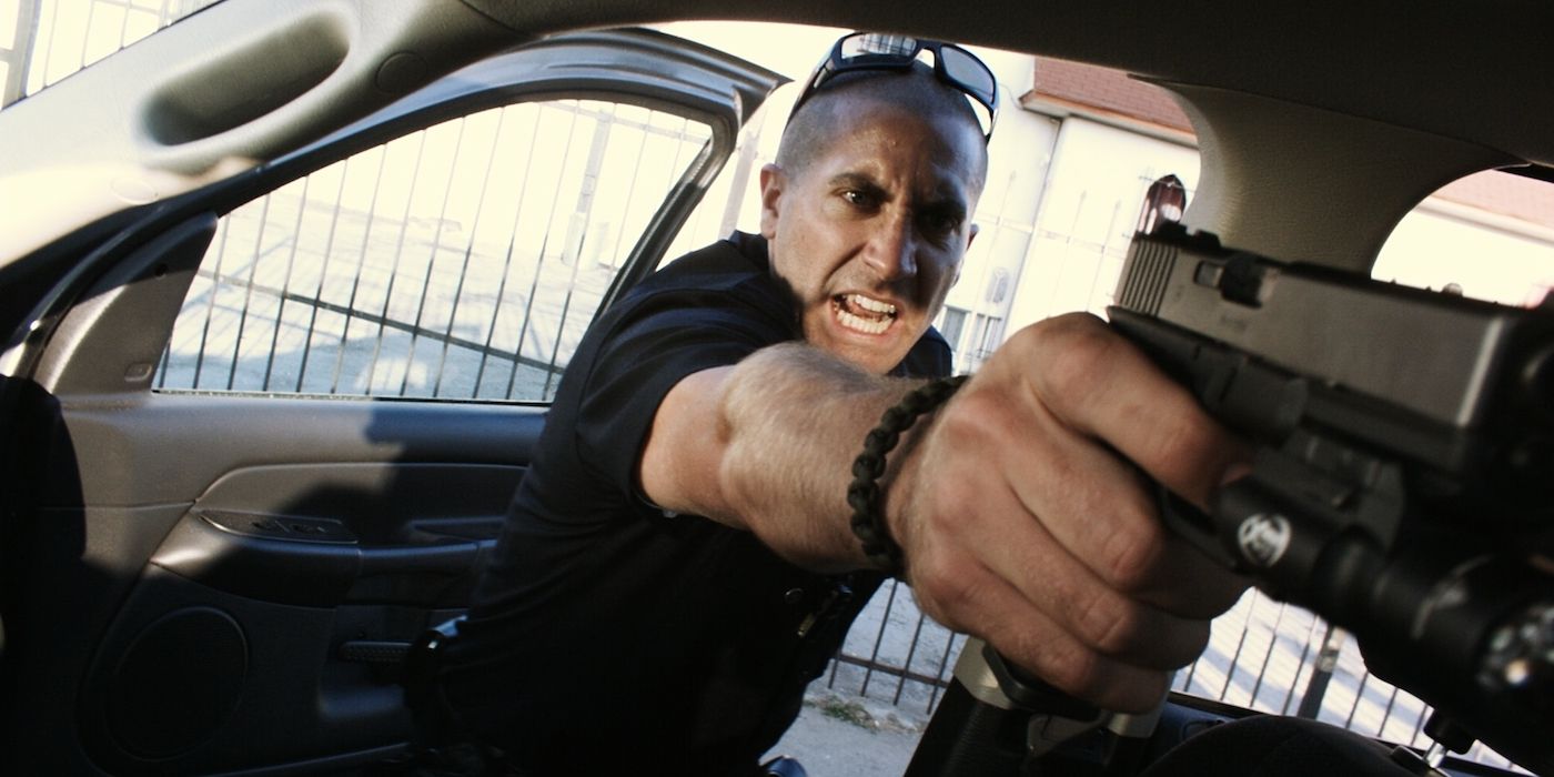 Jake Gyllenhaal as a police officer wielding a handgun in End of Watch