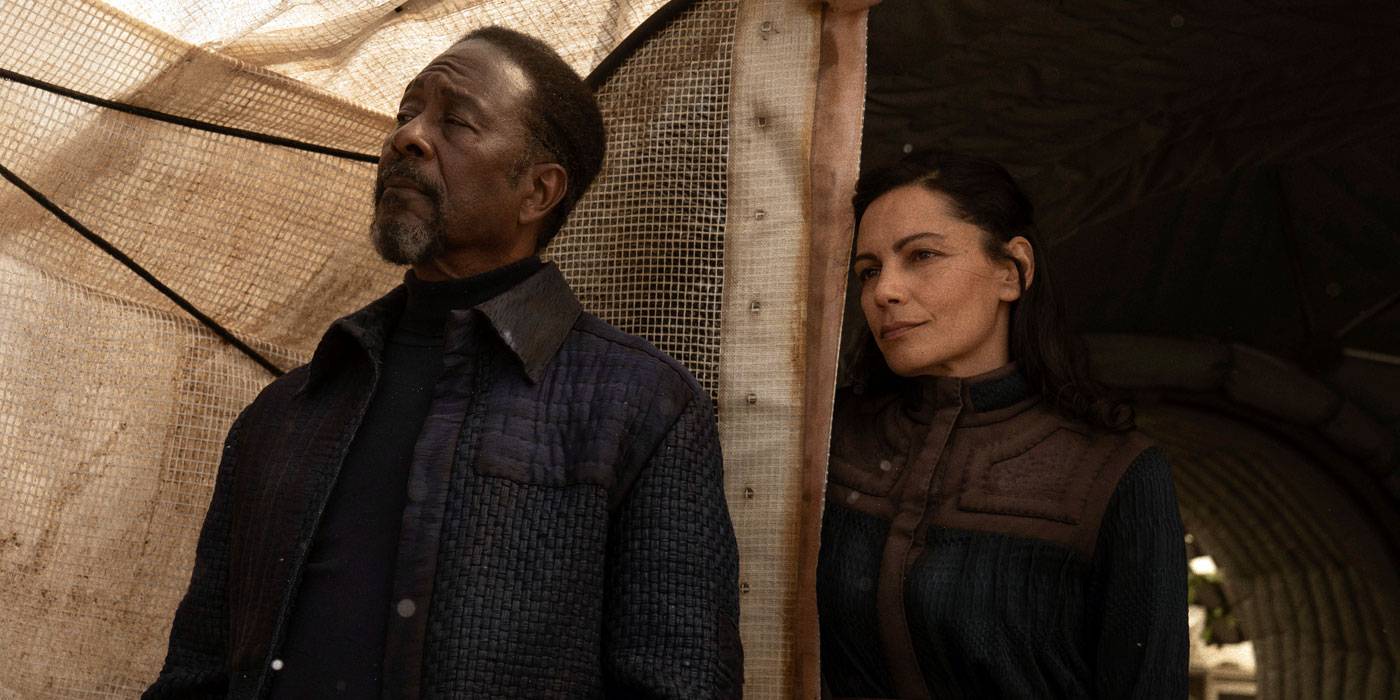 Abbas Hardin and Mari stand at the door of a tent in Foundation