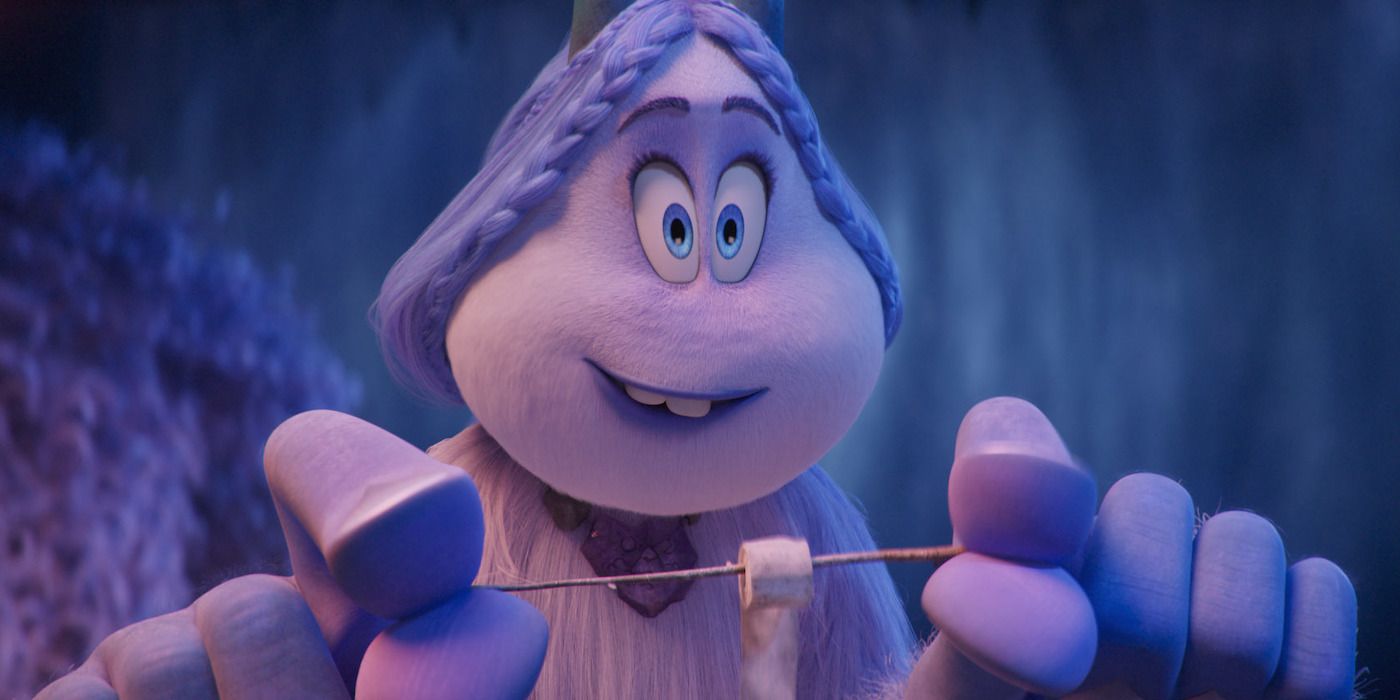 Meechee, a purple yeti with horns, holds a stick with a roasted marshmallow on it. 