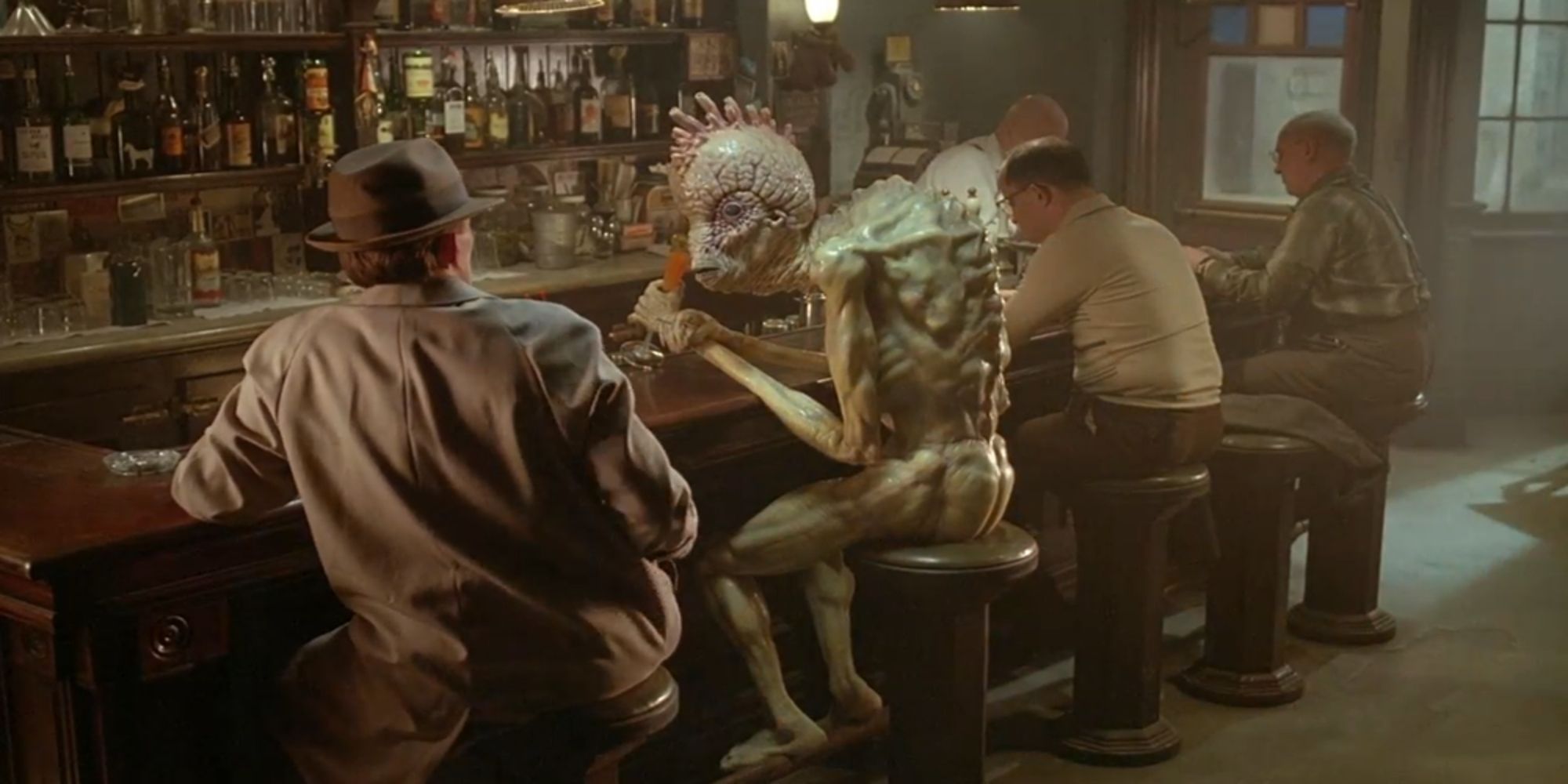 Peter Weller as Bill Lee at a bar with a Mugwump in Naked Lunch