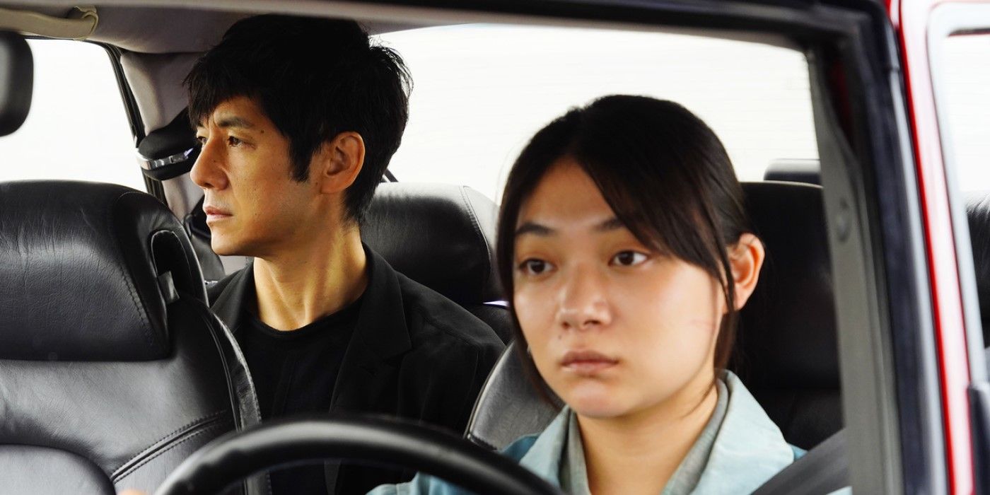 Hidetoshi Nishijima and Toko Miura as Yusuke and Misaki inside a car in the 2021 movie Drive My Car.