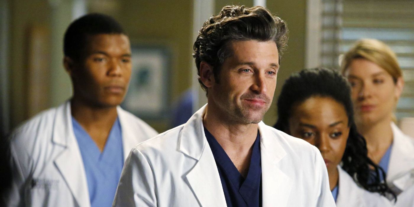 Patrick Dempsey as Derek Shepherd, smiling with a group of interns in Grey's Anatomy