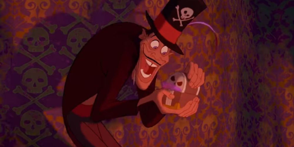 Dr Facilier smiling while holding a small chest in The Princess and The Frog