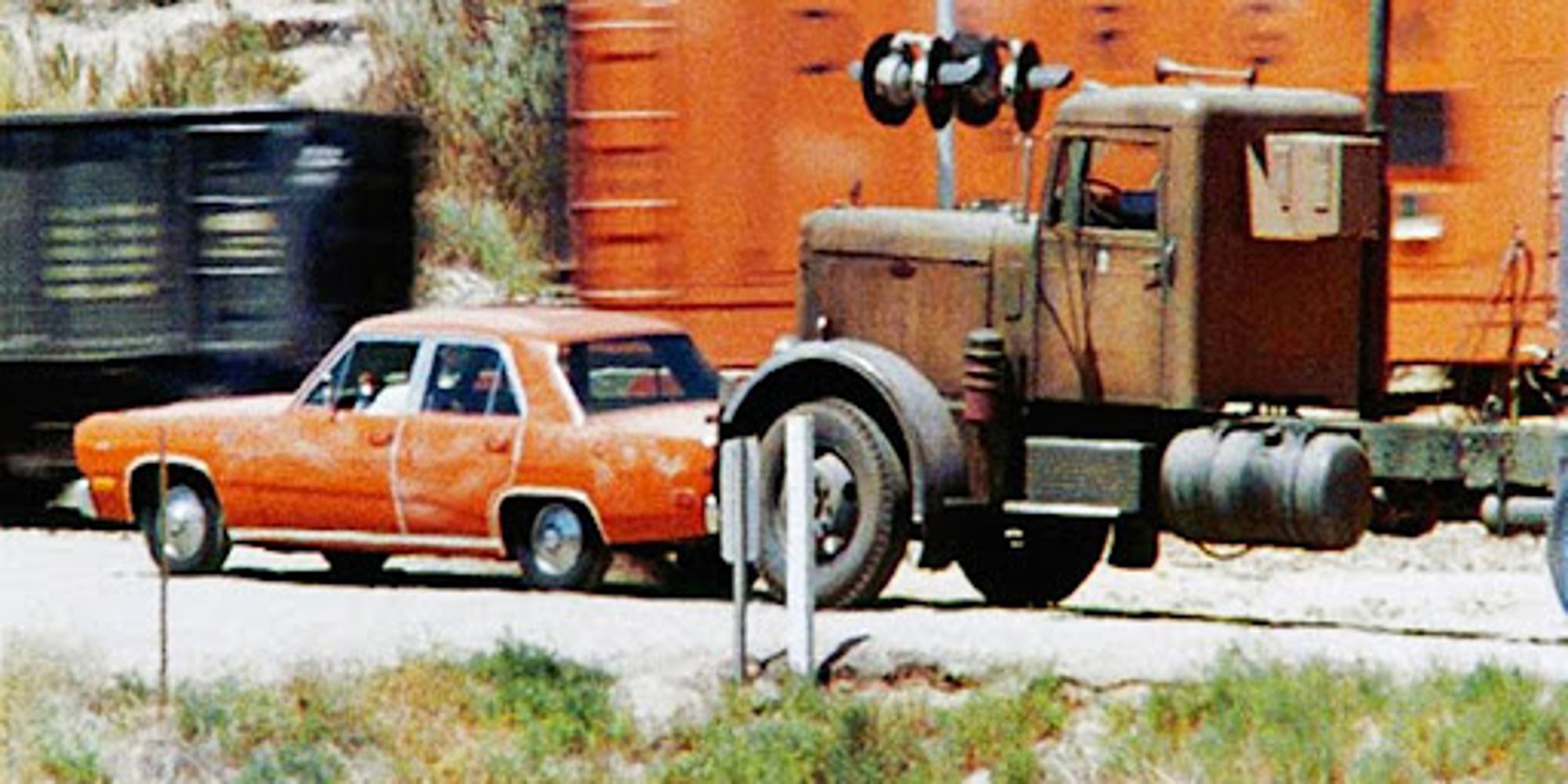 The Plymouth and the Big Rig are stopped at the tracks in Duel